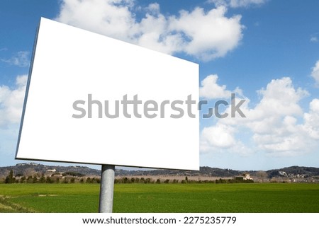 Blank advertising signboard in a rural scene with field - concept with copy space for text inserting 