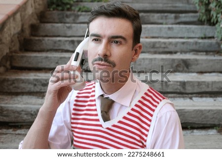 1990s businessman using the first mobile phone  Royalty-Free Stock Photo #2275248661