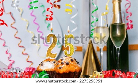 Solemn cake for an anniversary with a number  25. Happy birthday background with champagne bottle and champagne glasses. Beautiful holiday decorations copy space.