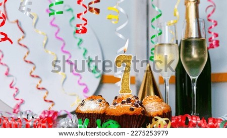 Solemn cake for an anniversary with a number  7. Happy birthday background with champagne bottle and champagne glasses. Beautiful holiday decorations copy space.