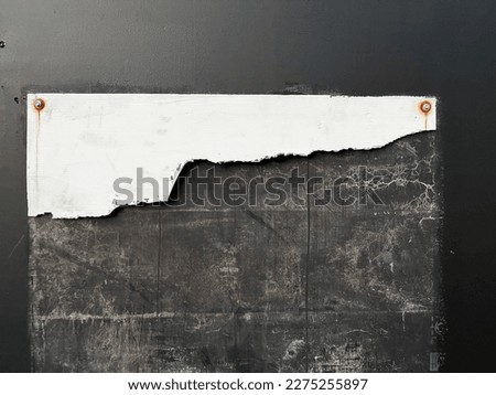 Cracked broken worn empty construction sign on black wooden urban background 