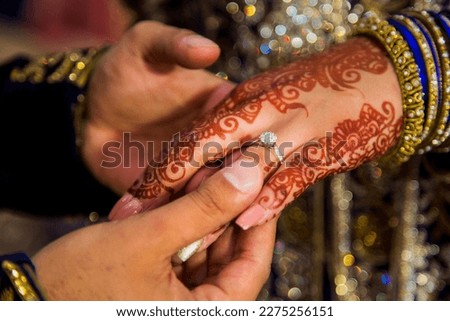 A wedding ring is a symbol of love and commitment exchanged by two individuals during their wedding ceremony. Royalty-Free Stock Photo #2275256151