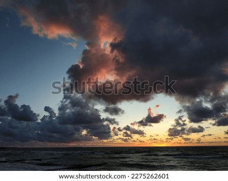 Huge clouds over the sea during sunset