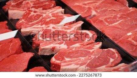 Red rib eye meat for sale in meat department in a shop. Raw fresh meat ribeye for steak perfectly arranged in trays. Royalty-Free Stock Photo #2275267873