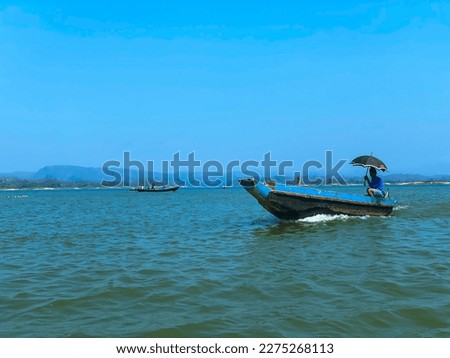 A boat with a man on it with an umbrella