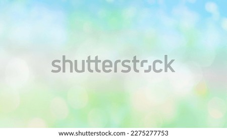 Blurry spring summer abstract background with bokeh lights. Natural blurred morning or day landscape with defocused sun lights on blue green background.