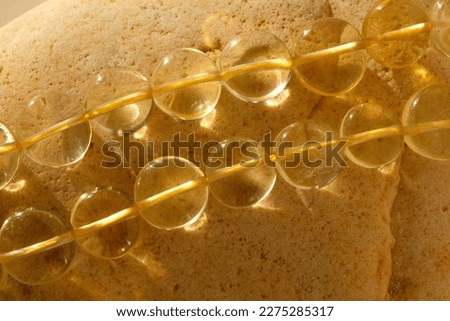 Beads in the shape of a coin made of lemon quartz.