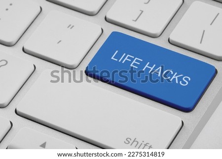 Blue button with words Life Hacks on laptop, closeup