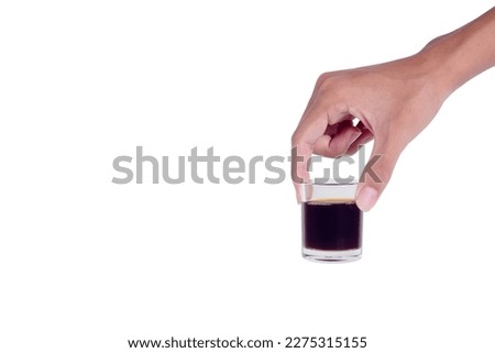Hand-hold mini glass cup of americano coffee isolated on a white background. Royalty-Free Stock Photo #2275315155