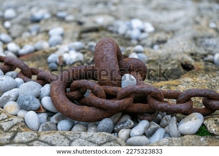 Fragment of old anchor chain on stone background. Marine theme and style. High quality photo