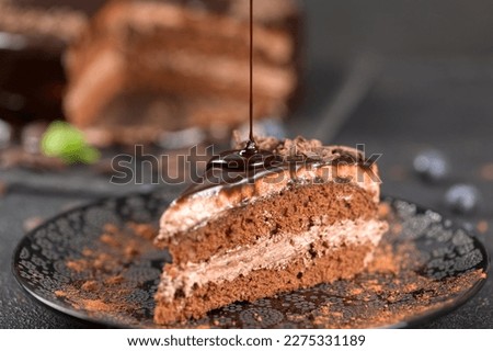 Cake decoration. Chocolate glaze. Chef decorated pie. Confectioner smears liquid chocolate glaze. Homemade baking concept Royalty-Free Stock Photo #2275331189