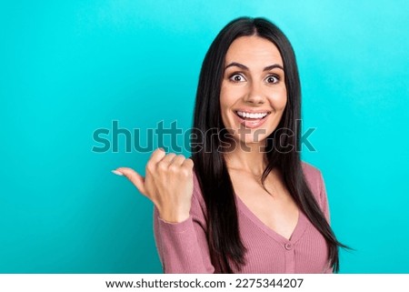 Photo of cheerful cute person beaming smile indicate thumb finger empty space isolated on teal color background