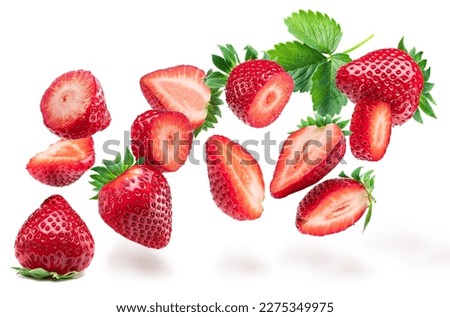 Strawberries and sliced strawberry flying in the air, isolated on white background. Royalty-Free Stock Photo #2275349975