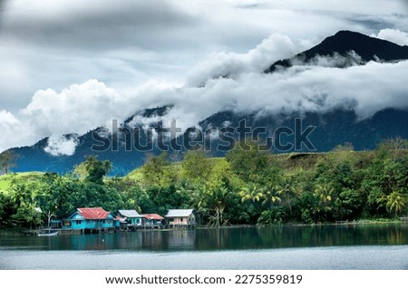 after the rain you can see the cyclops mountains from the old village of Danau Sentani. Royalty-Free Stock Photo #2275359819