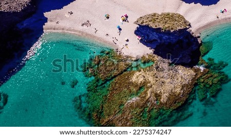 Seashore, coastline, scenic view of people at unspoiled beach in Almeria, called Playa de los Muertos, in English The beach of Deads due to the strong currents that cause many deaths year after year Royalty-Free Stock Photo #2275374247