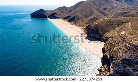 Seashore, coastline, scenic view of people at unspoiled beach in Almeria, called Playa de los Muertos, in English The beach of Deads due to the strong currents that cause many deaths year after year Royalty-Free Stock Photo #2275374251