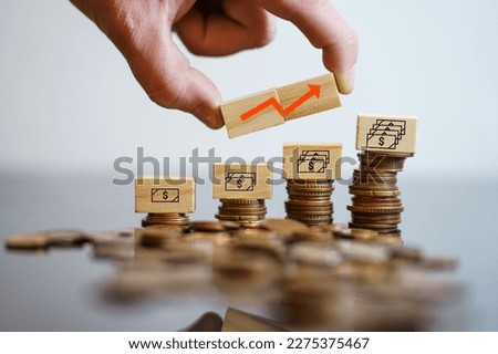 Cubes with money icons on coins showing the inflation of economy. Concept of growing inflation. High quality photo