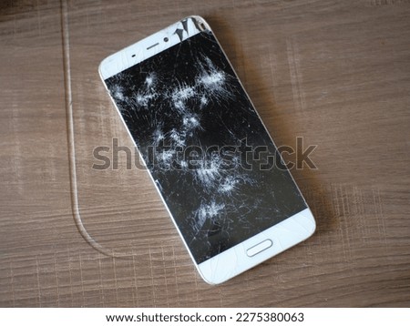 broken smartphone screen on the table,cracked smartphone screen