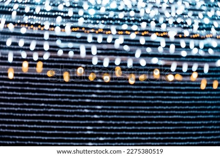 Abstract lights. Christmas street lights with straight lines shape, out of focus.  White and gold color lights. With black background. Tenerife, Canary Islands, Spain.