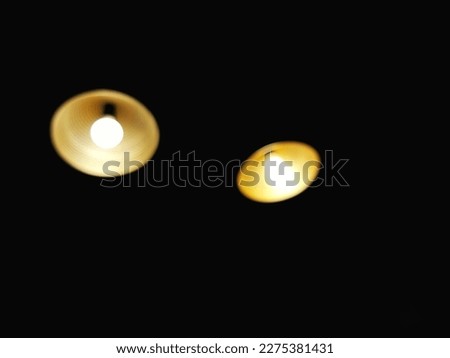 Defocused abstract background of lamp light in the darkness.