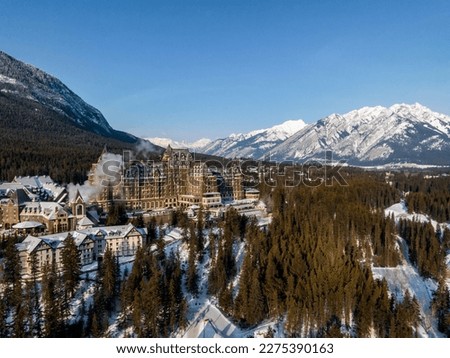  aerial view of Fairmont Banff Springs hotel during winter sunrise in banff with mountains on background Royalty-Free Stock Photo #2275390163