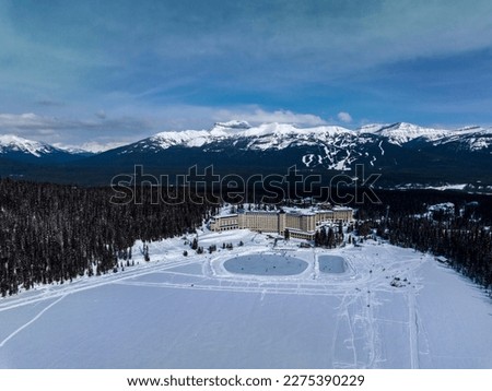 aerial view Fairmont Chateau Lake Louise hotel and two ice rinks on lake luise with mountains on background Royalty-Free Stock Photo #2275390229