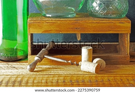 VINTAGE CORK SCREW WITH CORKS AND CLEAR AND GREEN GLASS BOTTLES