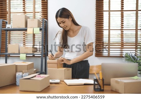 Asian woman preparing package delivery box Shipping for shopping online. young start up small business owner  Royalty-Free Stock Photo #2275406559