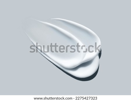 cosmetic smears of creamy texture on a gray background Royalty-Free Stock Photo #2275427323