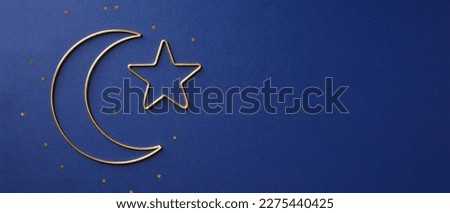 Golden Islamic star and crescent moon on dark blue background. Ramadan Kareem banner template.