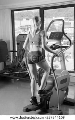 Image of fitness girl running on treadmill