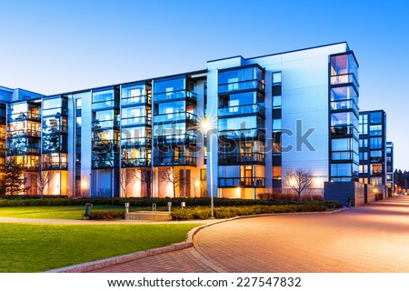 Creative abstract house building and city construction concept: evening outdoor urban view of modern real estate homes Royalty-Free Stock Photo #227547832