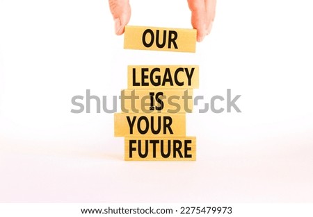 Legacy and future symbol. Concept words Our legacy is your future on wooden blocks. Beautiful white table white background. Businessman hand. Business legacy and future concept. Copy space. Royalty-Free Stock Photo #2275479973