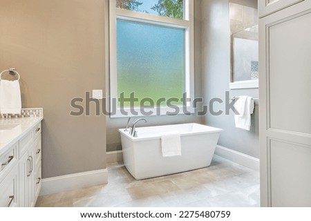 Interior bathroom photography with glass doors subway tile freestanding tub and pedestal sink slate floors granite counter towels claw footed bathtub and view windows  Royalty-Free Stock Photo #2275480759