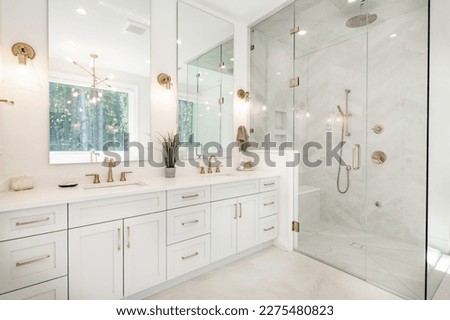 Interior bathroom photography with glass doors subway tile freestanding tub and pedestal sink slate floors granite counter towels claw footed bathtub and view windows  Royalty-Free Stock Photo #2275480823