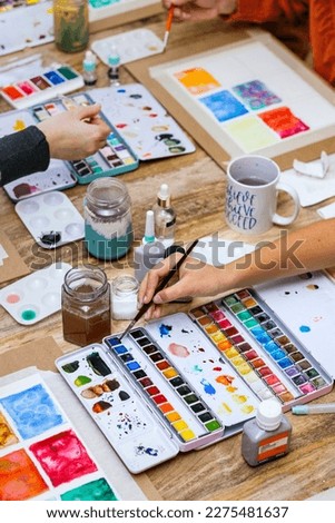 Spain Watercolor Workshop. Girls choosing colors to paint.