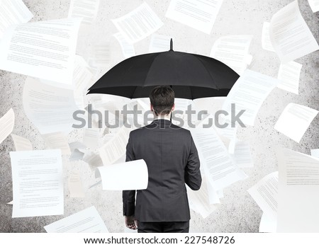 businessman is standing under the papers rain. Royalty-Free Stock Photo #227548726