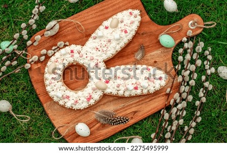 cake for easter.easter bunny with easter eggs and willow on green grass