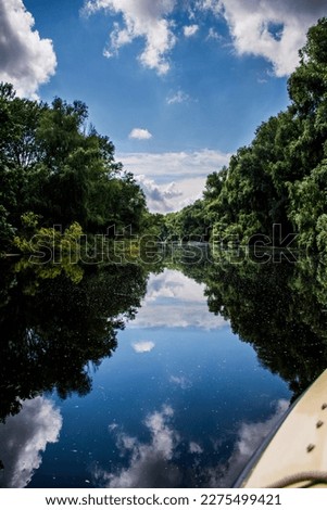 Focus on water while on a boat ride on a very calm Danube Delta channel