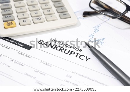 Bankruptcy form, calculator and pen on desk. Personal injury claim form Royalty-Free Stock Photo #2275509035