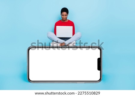 Full body photo of funky millennial lady sit write laptop on promo wear shirt jeans shoes isolated on blue background