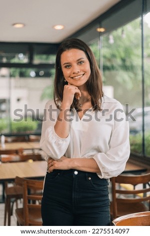 Director of a company, young, determined, intelligent and capable of achieving her goals. Vertical portrait photo for social networks posing with her hand on her face