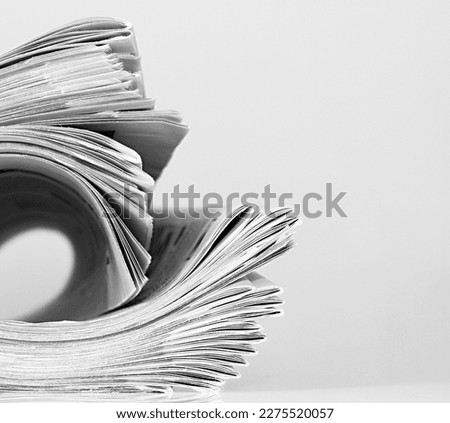 newspaper rolled up and sitting on a table no people stock photo Royalty-Free Stock Photo #2275520057