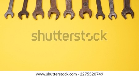 Old wrenches on a yellow background metal and rusty wrench isolated on yellow background
An old rusty wrench on a white background. Vintage wrench close-up.