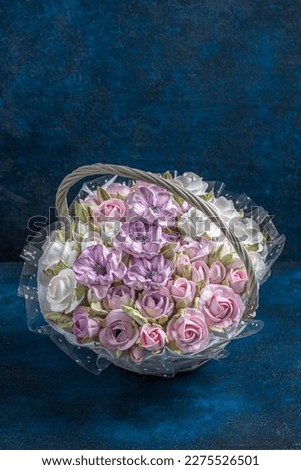 marshmallow bouquet of flowers in a basket on a blue background, sweets for gourmets