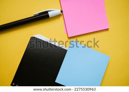 Pen diary and sticky notes on colorful background