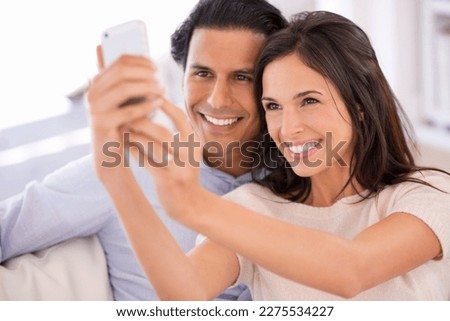 Happy husband and wife pic. A beautiful woman taking a photograph of herself and her husband.