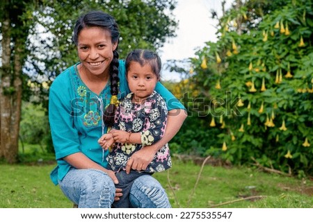 Portrait of mother with her daughter looking at the camera. Royalty-Free Stock Photo #2275535547