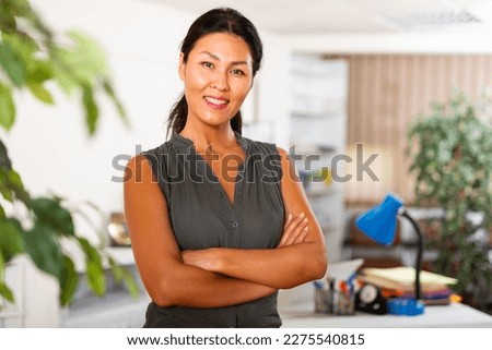 Portrait of successful asian business woman standing in her office with crossed arms Royalty-Free Stock Photo #2275540815