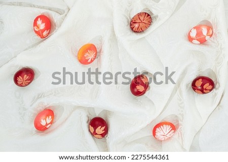 Easter eggs with a floral print on a textile background. Flat lay pattern. Holiday concept.